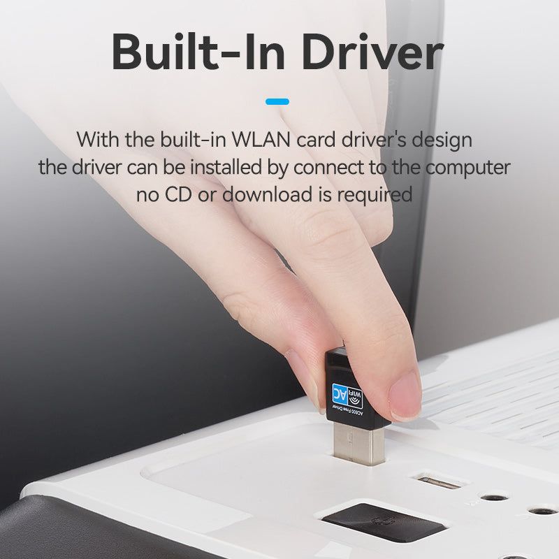 Hand plugging VENTION AC600 Dual Band Wi-Fi Adapter into a white laptop USB port showing built-in driver feature