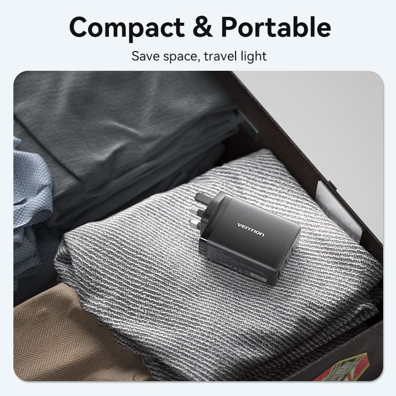VENTION GaN USB charger 100W in a travel case with folded clothes for compact and portable charging